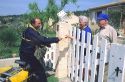 A postal worker delivering mail to a residence in rural France.