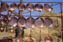 Copper pans displayed for sale at roadside stand in Chile.