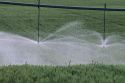 Sprinkler pivot irrigation in eastern Idaho wheat field.