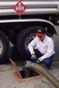 A worker delivering gasoline.