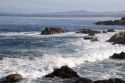 Waves crash along the rocky shore in Monterey, California.