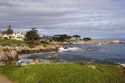 People jogging along the rocky shore in Monterey, California.