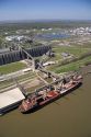 Grain elevators and river barge being loaded along the Mississippi River near New Orleans, Louisiana.