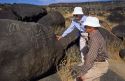Man and woman looking at petroglyphs in Idaho along the Snake River.