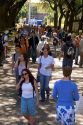 Students walking and using cell phones on the campus of University of Texas in Austin.