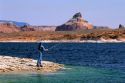 A woman fisherman using a spinning reel at Lake Powell in Southern Utah.