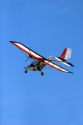 An ultralight aircraft flying in the sky.