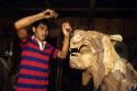 A woodcarver working with chisel and hammer in the Philippines.