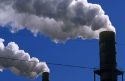 Smoke stacks emit air pollution at a manufacturing plant.