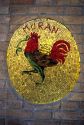 A mosaic of a rooster with snake symbol of muran in Venice, Italy.
