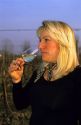 An Italian woman sampling wine in a glass, Italy.