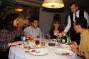 A waiter serves tapas to a table in Barcelona, Spain.