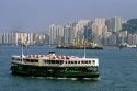 Star Ferry and skyscraper buildings at Hong Kong Harbor.
