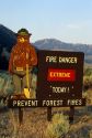 A forest service sign with Smokey Bear warning of extreme fire danger in Idaho.