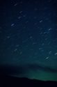 A night sky with star trails in Idaho. Streaks caused by earth rotation during time exposure. Different colors caused by the gases on the stars.