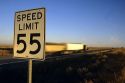 Speed limit 55 road sign with traffic on the interstate in Idaho.