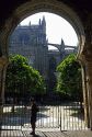 View of the Cathedral through an arched gate of the Alcazar of Seville, Spain.
