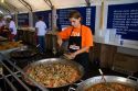 Worker serves a seafood dish of paella at Mar del Plata, Argentina.