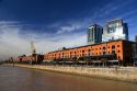 Modern office buildings and older red brick building at Puerto Modero in Buenos Aires, Argentina.