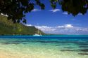 A sailboat anchored in the lagoon off the island of Moorea.