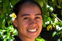 Tahitian woman wearing a plumeria flower in her hair on the island of Moorea.