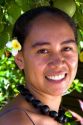 Tahitian woman wearing a plumeria flower in her hair on the island of Moorea.