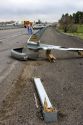 Automoblie accident scene with skid marks and broken guard rail on the interstate near Jerome, Idaho.