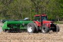 Tractor using the practice of minimum tillage for planting soy beans over last years corn crop near Clarksville, Michigan.