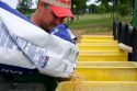 A farmer loading soy bean seeds into a planter in the east central delta region of Arkansas.