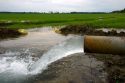 Water flowing from an irrigation pipe into a rice field in the delta region of east central Arkansas.