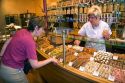 Woman purchasing cookies at a bakery in Strasbourg, France.
