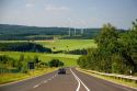 Electricity wind generators and automobiles traveling on the highway in northwest Germany.