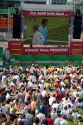 A crowd outdoors at the Munich airport watch a 2006 World Cup match on big screen televisions, Germany.