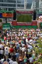 A crowd outdoors at the Munich airport watch a 2006 World Cup match on big screen televisions, Germany.