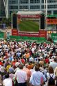 A crowd outdoors at the Munich airport watch a 2006 World Cup match on big screen televisions, Germany.