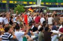 A crowd of soccer fans gather outdoors at the Munich airport watch a 2006 World Cup match on big screen televisions, Germany.
