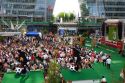 A crowd of soccer fans gather outdoors at the Munich airport watch a 2006 World Cup match on big screen televisions, Germany.