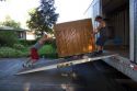 Movers push a piano up a ramp into the moving truck in Boise, Idaho.