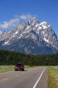 Vehicles travel on the highway through Grand Teton National Park, Wyoming.