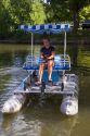 Fifteen year old girl uses a paddlewheel boat on the lagoon in Julia Davis Park, Boise, Idaho.