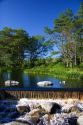 Water flows over a small dam at a mill near Barrington, Nova Scotia, Canada.