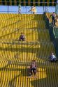 Children ride down a giant yellow slide at the Iowa state fair in Des Moines.