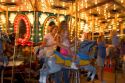 Children and adults ride a carousel at the Iowa state fair in Des Moines.