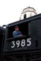 Railroad engineer at the window of a vintage Challenger steam engine visiting Boise, Idaho.