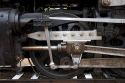 Close up detail view of steam locomotive drive wheel.