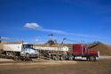 Trucks dump harvested sugar beets into collection piles in Mountain Home, Idaho.