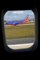 Southwest Airlines Boeing 737 seen through the window of an airliner.