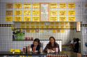 People eat at a lanchanette, cafe, restaurant in the Liberdade asian section of Sao Paulo, Brazil.
