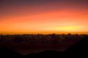 Sunrise above the clouds on the island of Maui, Hawaii atop Mount Haleakala.