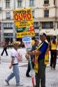 Man holding a sign advertising for a jewelry store in Sao Paulo, Brazil.